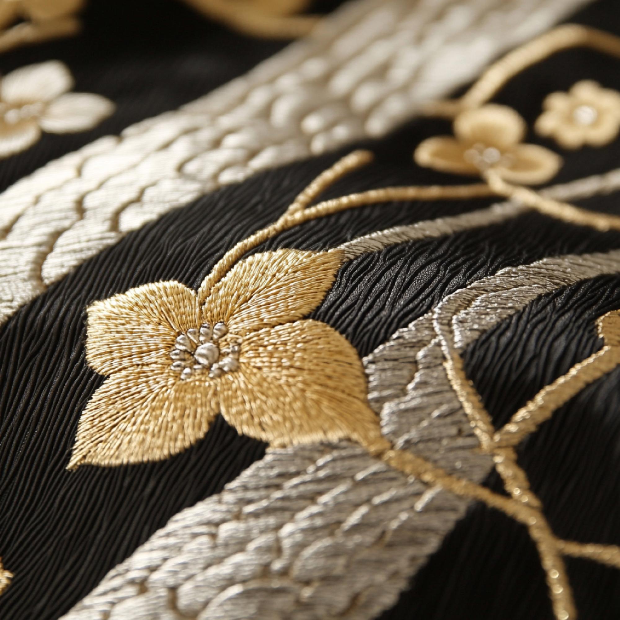 Close-up of gold-thread hand embroidery on silk